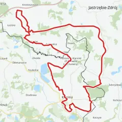 Mapa z zaznaczoną czerwoną trasą rowerową, prowadzącą przez tereny z nazwami miejscowości jak Łaziska, Petrovice, Karviná, Zebrzydowice.